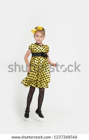 A little girl dressed in the style of the 60s