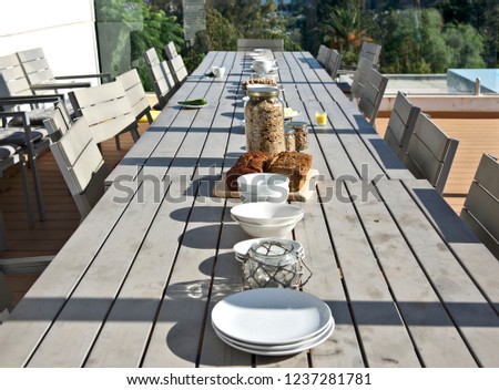 Table served for family dinner, outside. Wooden table in the farmhouse