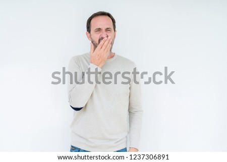 Elegant senior man over isolated background bored yawning tired covering mouth with hand. Restless and sleepiness.
