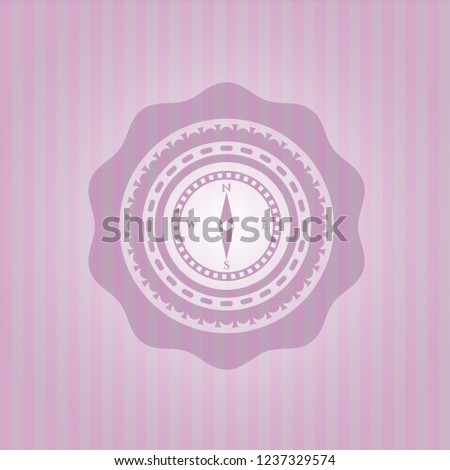compass icon inside pink emblem