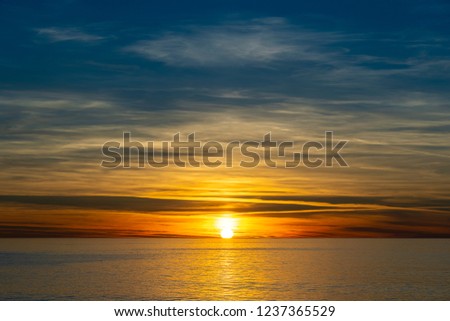 Beautiful sunset over calm sea. Summer vacation concept.