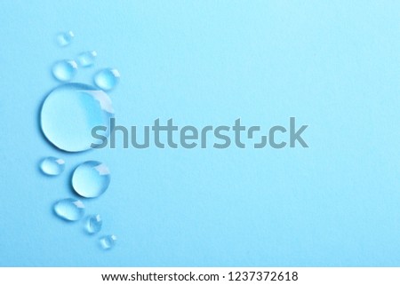 Water drops on color background, top view. Space for text