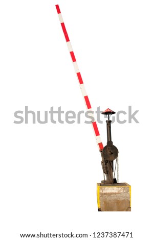 Old fashioned funny hand operated railway crossing barrier isolated on white background. Mushroom painting at the top of the bell