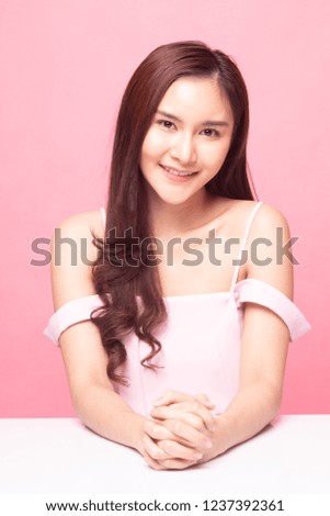 Portrait of beautiful young Asian woman on pink background