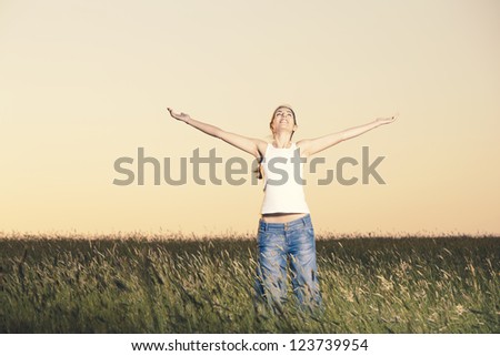 Outdoor portrait of a woman on a meadow releaxing Royalty-Free Stock Photo #123739954