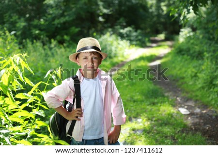 Little boy walking in forest