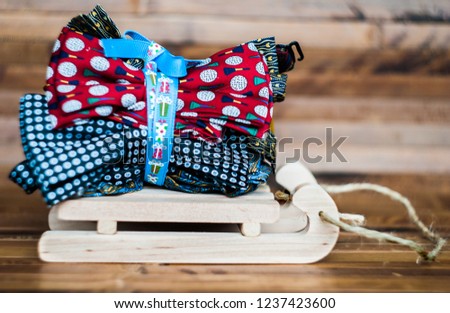 Heap of bow tie on wooden sledges. Colorful accessories. A gift for winter holidays. 