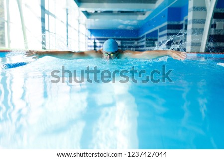 Photo of sportive man swimming in pool