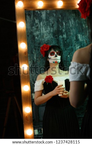 Image of zombie woman with white face and red flower on her head