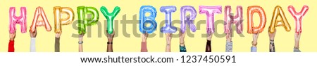 Hands holding Happy Birthday word in balloon letters