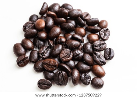 The roasted coffee beans on the white background