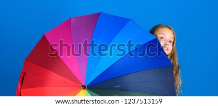 Colorful umbrella accessory. Weather forecast concept. Stay positive though rainy day. Brighten up life. Kid peek out colorful rainbow umbrella. Color your life. Girl cheerful hide behind umbrella.