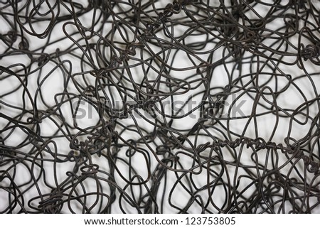 Background image of wires in a chaotic fashion against white background