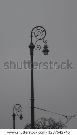Rounded old style street lamps on a gloomy day in the city of Zagreb in black and white