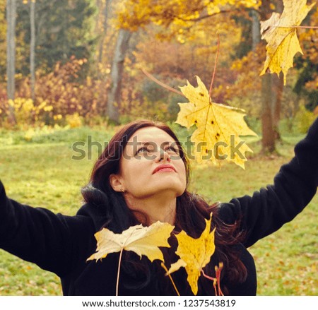 Young woman in garden enjoys autumn close up