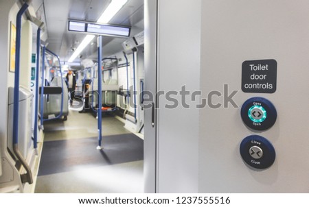 Automatic door occupied lavatory toiled open and close button on train in UK. Train toilet door lock and unlock system control.
