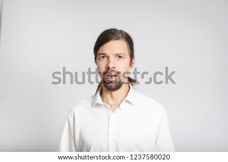 handsome business man shocked, long haired isolated on background