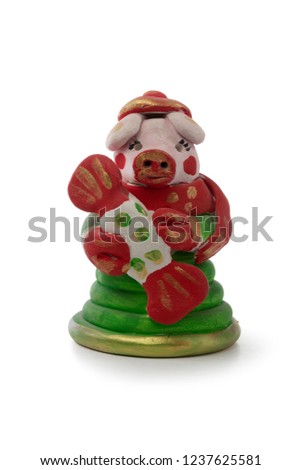 Pig is holding candy. Toy from the baked clay (Filimonovskaya toy). Folk art.