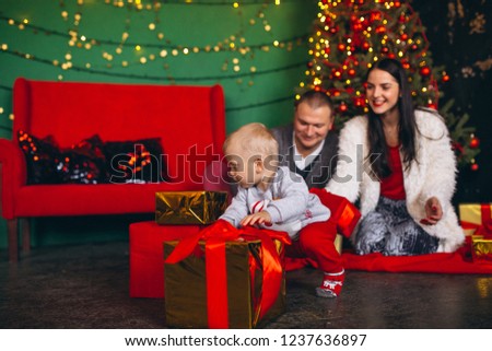 Family on Christmas by the Christmas tree