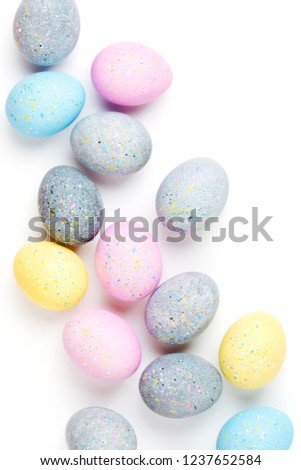 Background with pale pink, blue, yellow and gray Easter eggs. Compositions in pastel colors.  Easter concept