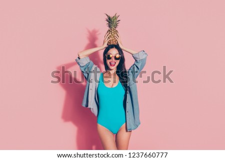 Rest relax chill concept. Glad optimist lady with her wave curly hair she stand wear in sun spectacles denim jeans shirt isolated on pastel pink background hold tasty juicy healthy food on head