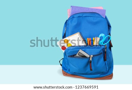 School Backpack with stationery on background Royalty-Free Stock Photo #1237669591