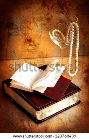 retro picture of a necklace lying on a book/ /romantic vintage background with  and blank page