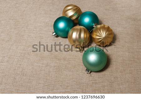 green and gold christmas balls on light brown fabric