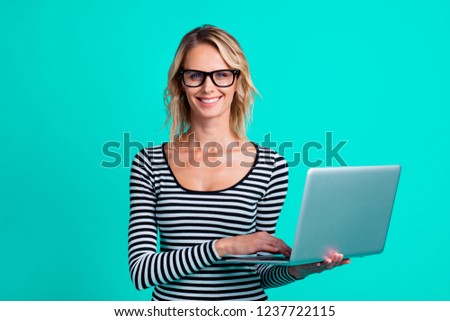 Photo of attractive dreamy carefree careless style stylish lady with her charming smile she stand isolated on vivid turquoise background using gadget