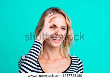 Close-up portrait of nice lovely charming adorable magnificent attractive cheerful positive optimistic wavy-haired girl showing ok-sign on eye isolated over bright vivid shine turquoise green 