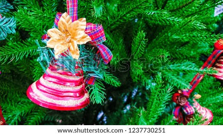 Beautiful Christmas ornaments. Christmas decoration in the form of the colorful bell, in the background, branches Christmas tree.