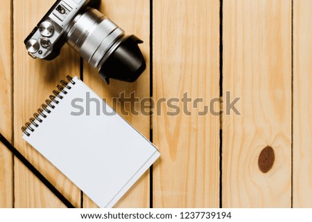 Camera on wooden background.