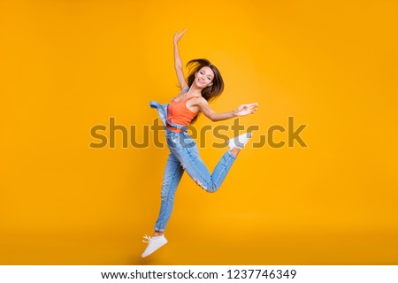Full length body size of nice crazy cute adorable attractive charming cheerful positive girl flying going in air isolated over bright vivid shine yellow background