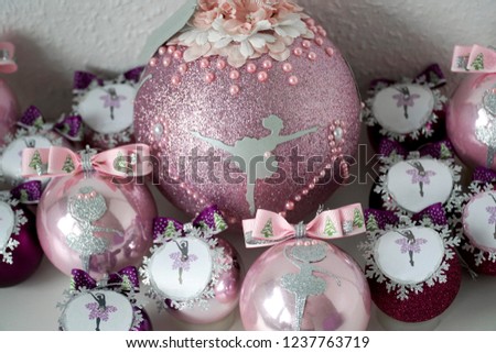 Many pink Christmas tree balls, decorated with sparkles, pearls, with silver ballerinas 