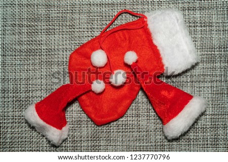 Christmas decoration red stocking on grey fabric background close-up