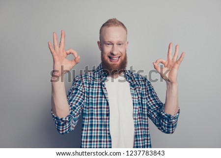 Photo portrait of attractive handsome nice man give ok-sign on two hands look at camera make beaming toothy smile stand isolated on light gray wall