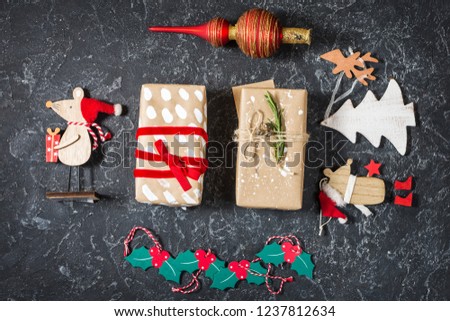 Christmas composition. Christmas gifts, toys on black stone background. Flat lay