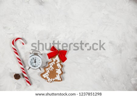 Christmas holiday background with vintage alarm-clock, Candy canes plastering background. Close-up, top view. Christmas and New Year concept