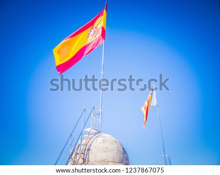 A Valencian and a Spanish flags over the Torres de Quart o Puerta de Quart which are medieval gothic gates located in the Guillen de Castro and Quart streets, in the city of Valencia, in Spain, Europe