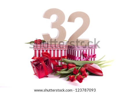 Number of age in a colorful studio setting and Dutch looking attributes like a clog wooden shoe and tulips
