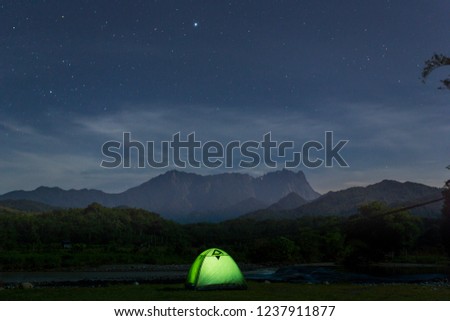 Camping under the Moonlight from Tegudon Tourism Village, Sabah, Malaysia. Photo contains noise, grains or blurry due to long exposure shot at night
