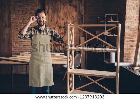 Cabinet wardrobe wall unit handicraftsman cabinetmaker free time concept. Cheerful satisfied handsome master carver show what he made standing in loft brick wooden room Royalty-Free Stock Photo #1237913203