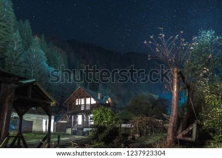 Wooden house at night and stars