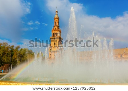 picture of a rainbow in a fountain in front of the palace of the Plaza de Espana in Seville, Spain