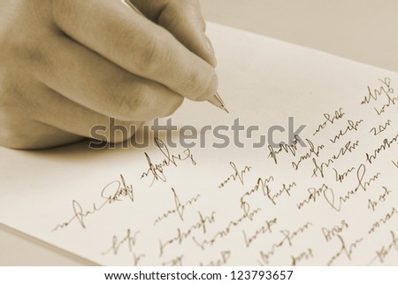 Male hand writing on a paper