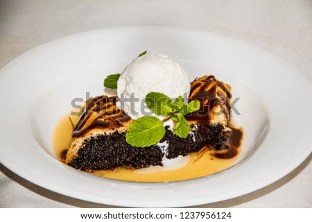 poppy seed cake with ice cream and mint, the plate of food, close up