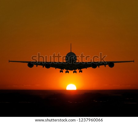 Jet getting ready for landing at dusk to dawn 