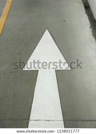 White arrows tell you the way to and from Thailand on an overpass.