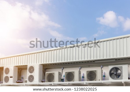 Group of External air conditioning and compressors units outside a building with blue sky background