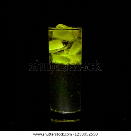 Yellow Sparkling iced alcohol drink with isolated black background